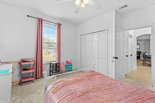 a bedroom with a bed and a chandelier