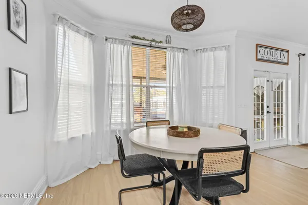 a view of a dining room with furniture and window