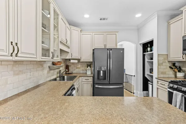 a kitchen with stainless steel appliances granite countertop a refrigerator and a sink