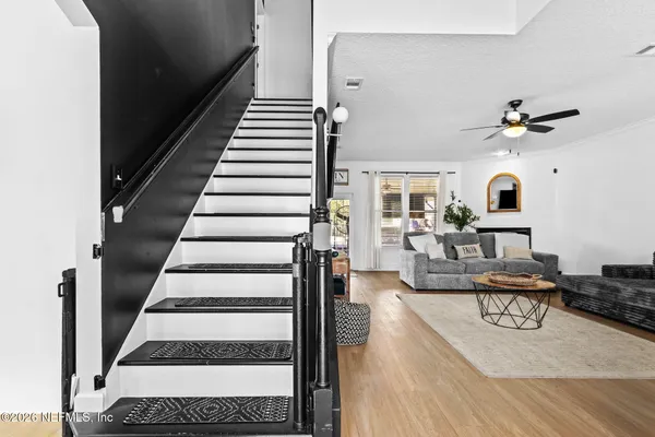 a view of entryway and hall with wooden floor