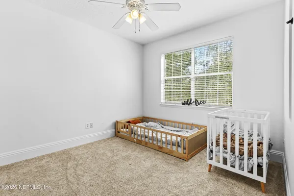 a spacious bedroom with a bed and a window