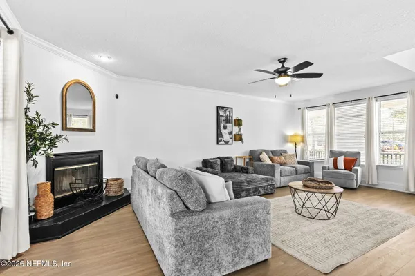 a living room with furniture fireplace and window