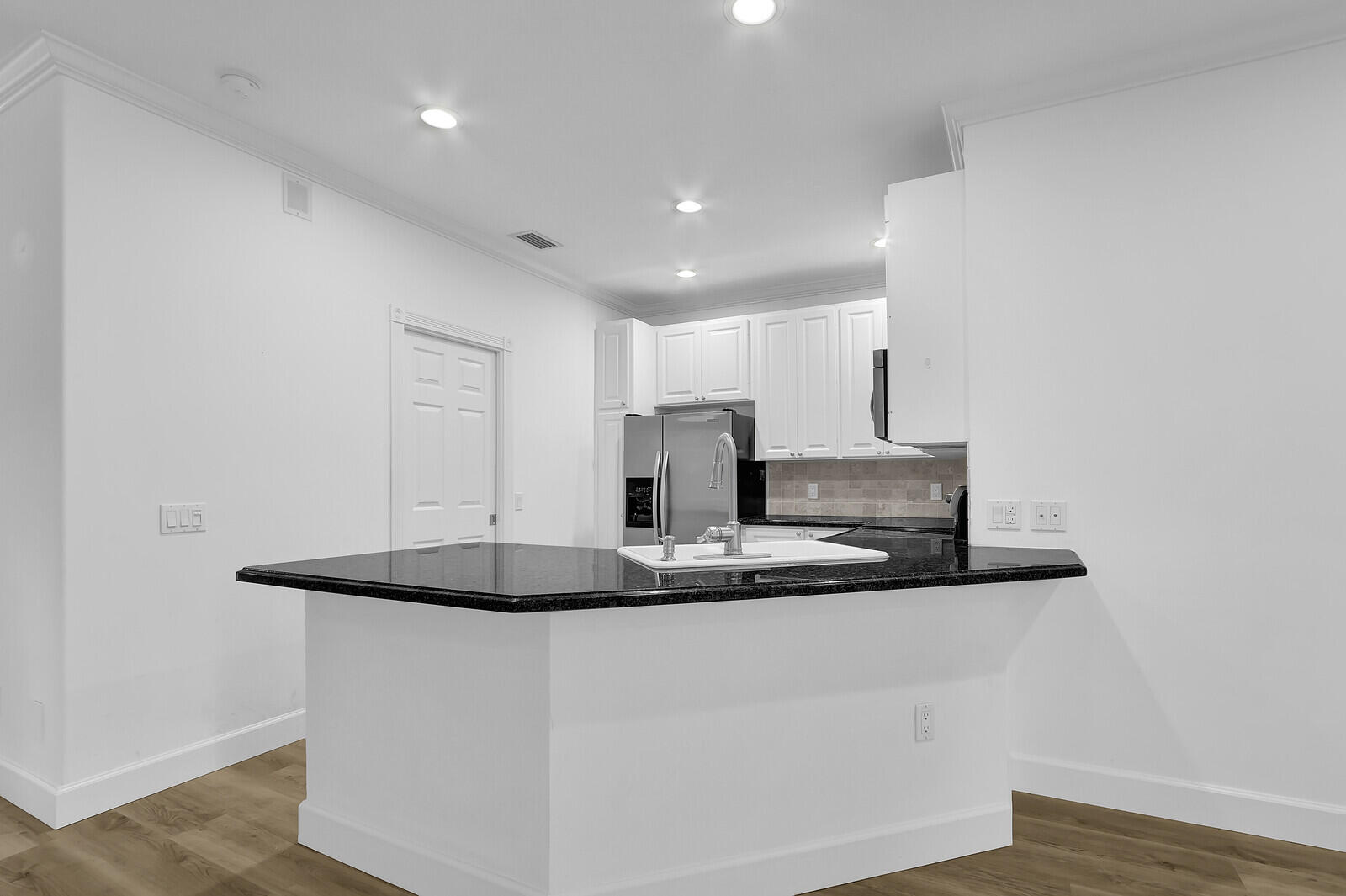 199 Barbados Drive Jupiter, FL 33458 - Photo 11 of 38 a kitchen with kitchen island stainless steel appliances a sink and a refrigerator