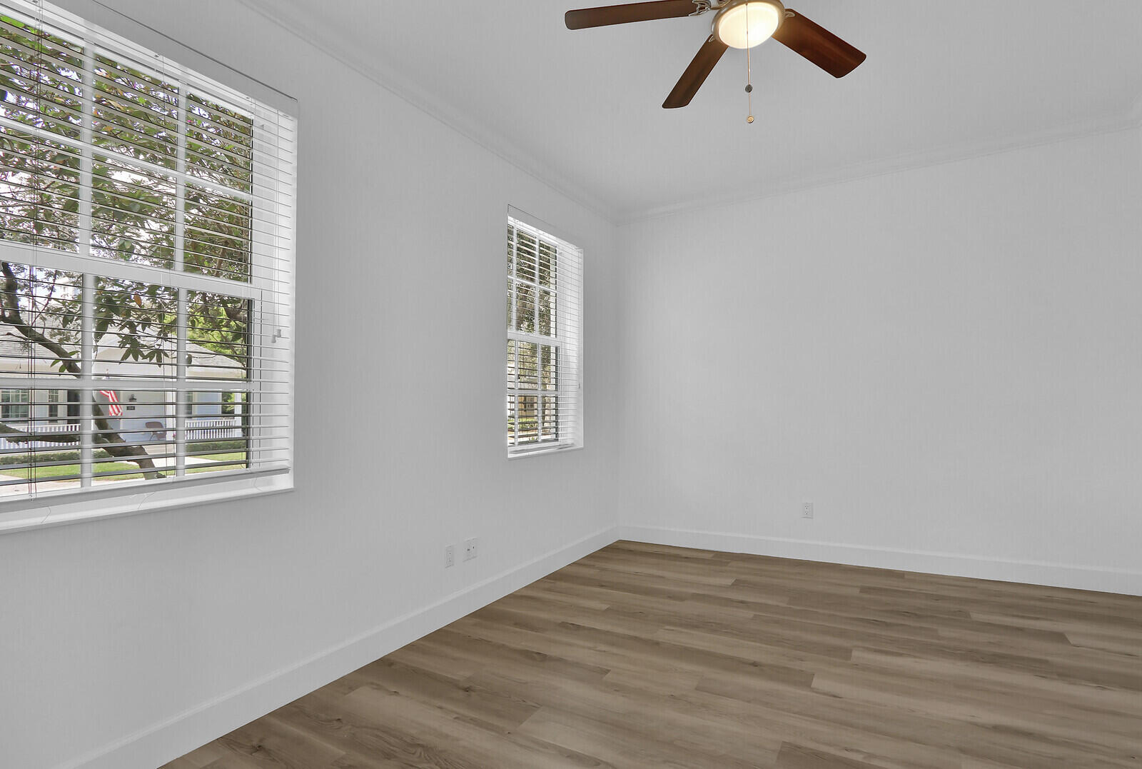 199 Barbados Drive Jupiter, FL 33458 - Photo 4 of 38 a view of empty room with wooden floor and fan
