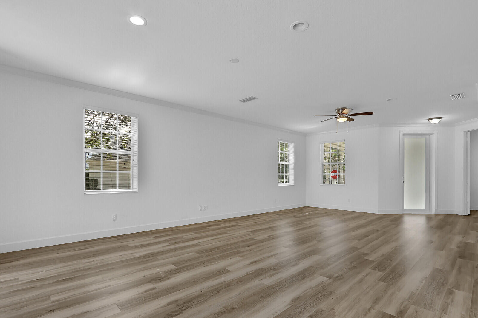 199 Barbados Drive Jupiter, FL 33458 - Photo 9 of 38 a view of an empty room with wooden floor and a window