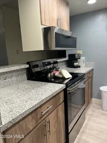 a kitchen with a sink stove and microwave