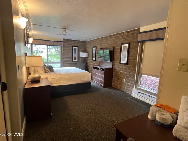 a bedroom with bed and window