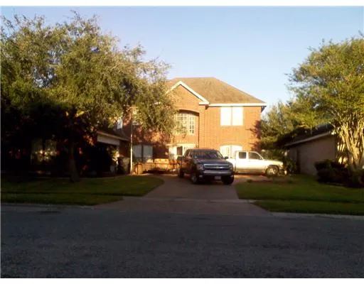 a view of a house with truck parked on the road