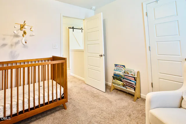 a view of a bedroom with furniture and wooden floor