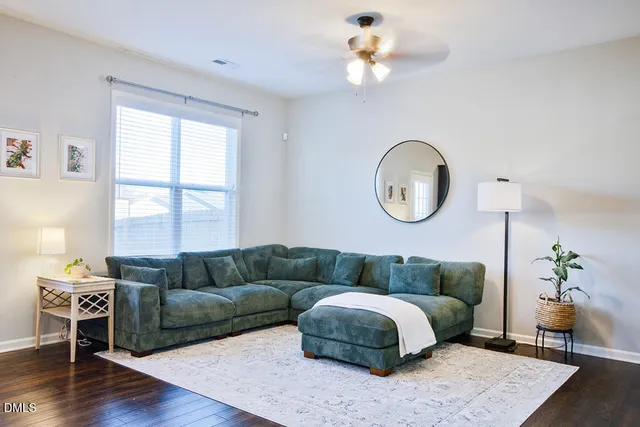a living room with furniture rug and window