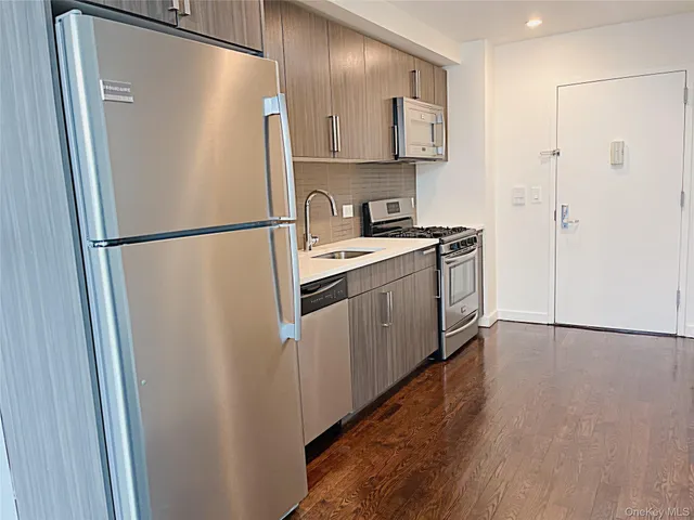 a white refrigerator freezer sitting inside of a kitchen