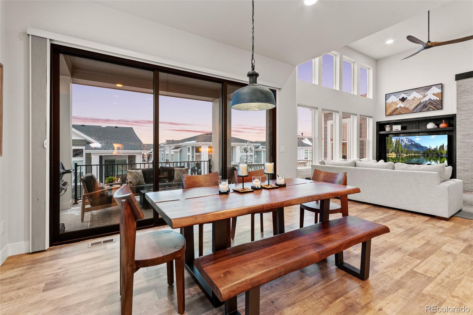 9388 Dunraven Loop Arvada, CO 80007 - Photo 13 of 50 a view of a dining room with furniture large windows and wooden floor
