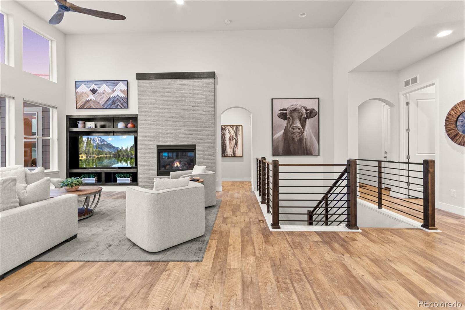 9388 Dunraven Loop Arvada, CO 80007 - Photo 18 of 50 a living room with furniture and a fireplace