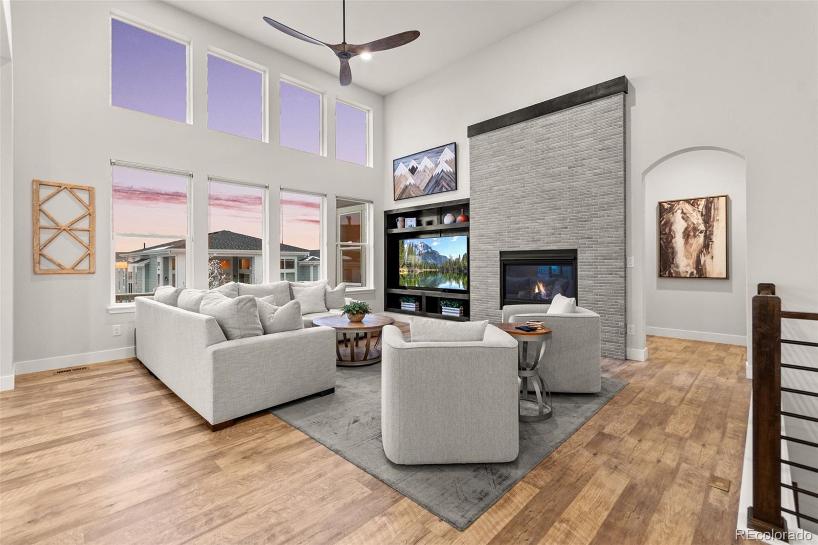 9388 Dunraven Loop Arvada, CO 80007 - Photo 19 of 50 a living room with fireplace furniture and a large window