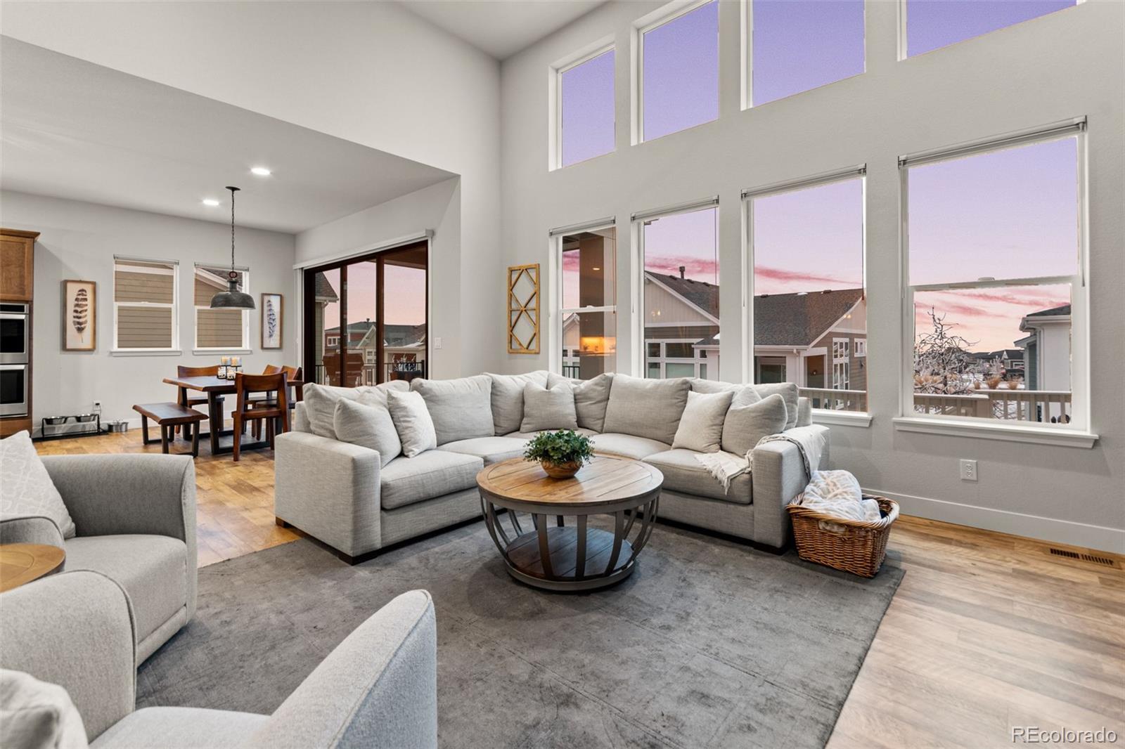 9388 Dunraven Loop Arvada, CO 80007 - Photo 20 of 50 a living room with furniture a large window and a table