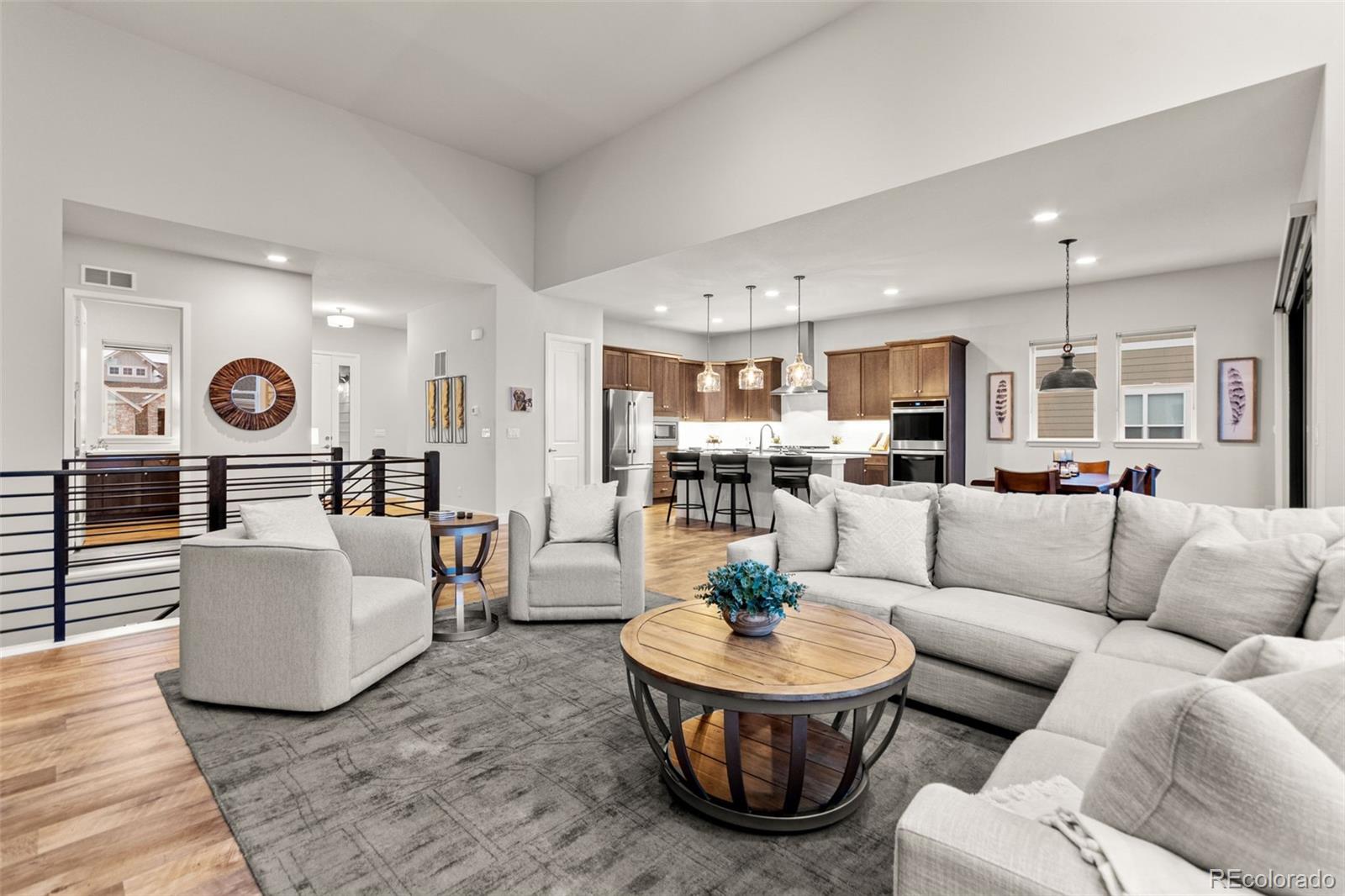 9388 Dunraven Loop Arvada, CO 80007 - Photo 21 of 50 a living room with furniture and view of kitchen