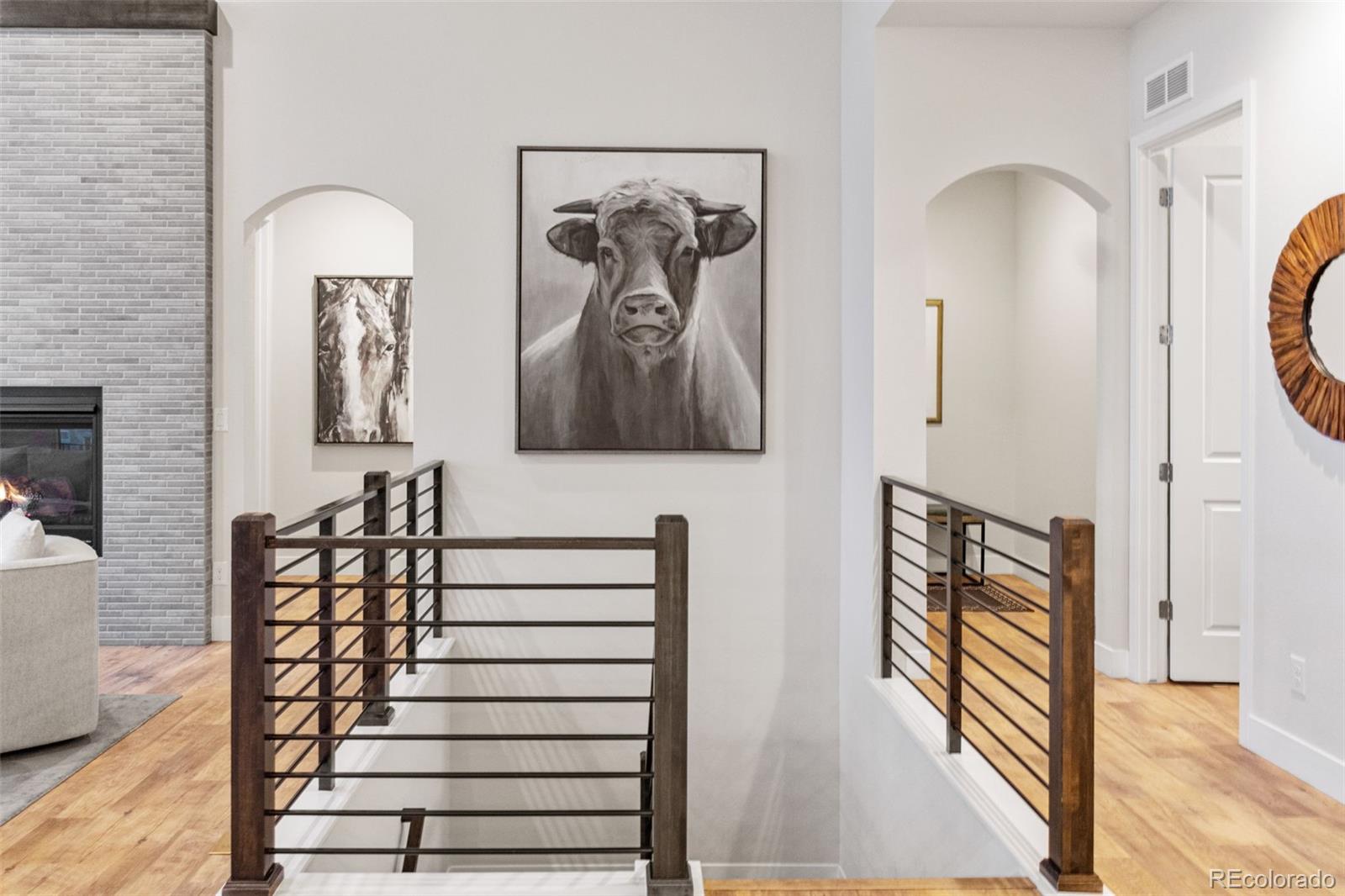 9388 Dunraven Loop Arvada, CO 80007 - Photo 23 of 50 a view of a hallway with wooden floor and entryway