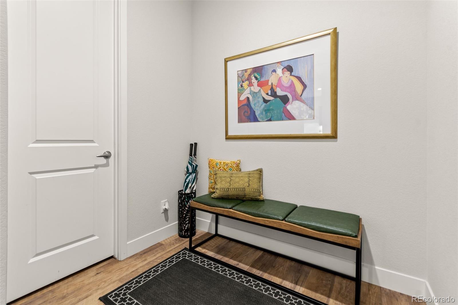 9388 Dunraven Loop Arvada, CO 80007 - Photo 25 of 50 a bench sitting in a room next to a window