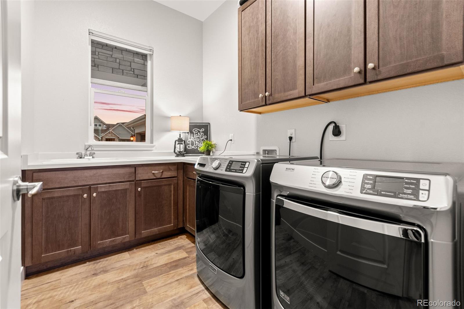 9388 Dunraven Loop Arvada, CO 80007 - Photo 26 of 50 a utility room with sink dryer and washer