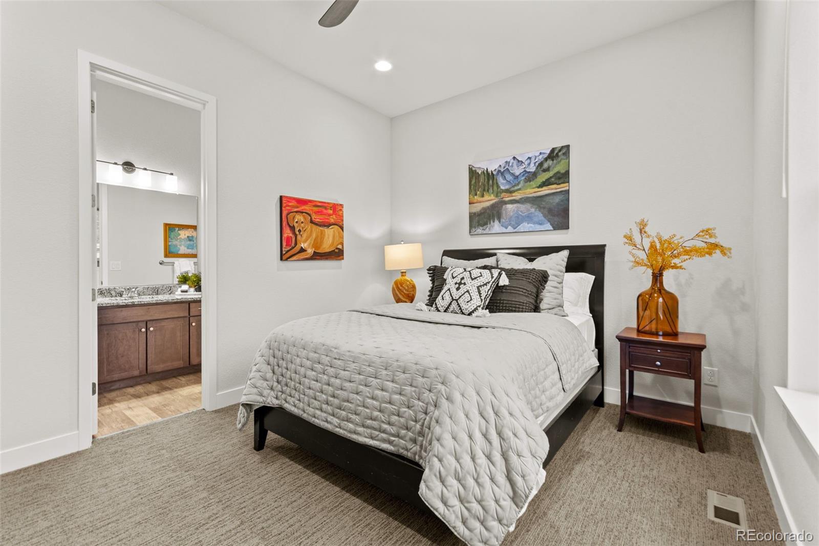 9388 Dunraven Loop Arvada, CO 80007 - Photo 30 of 50 a bedroom with a bed and a cabinets