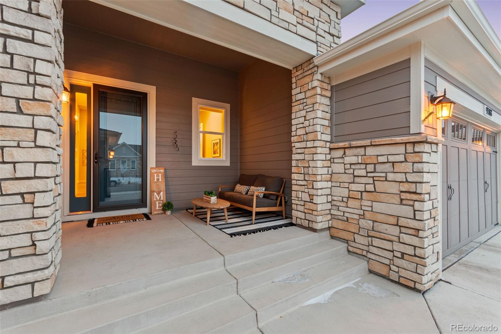 9388 Dunraven Loop Arvada, CO 80007 - Photo 3 of 50 a backyard of a house with barbeque oven table and chairs