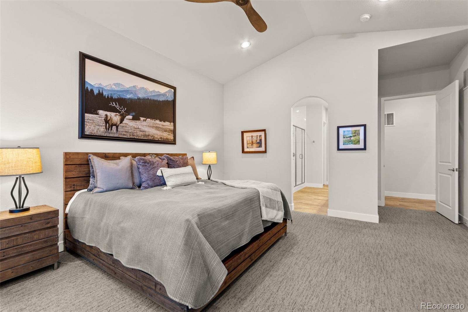 9388 Dunraven Loop Arvada, CO 80007 - Photo 33 of 50 a bedroom with bed and wall painting