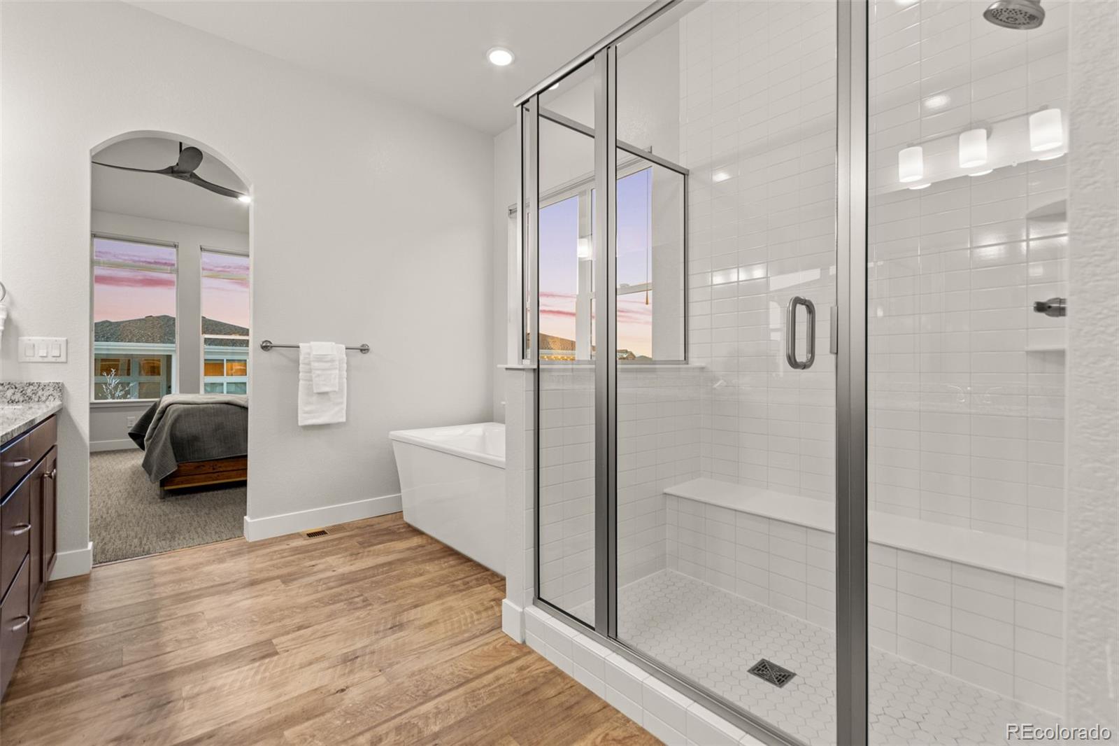 9388 Dunraven Loop Arvada, CO 80007 - Photo 35 of 50 a bathroom with a tub shower and sink