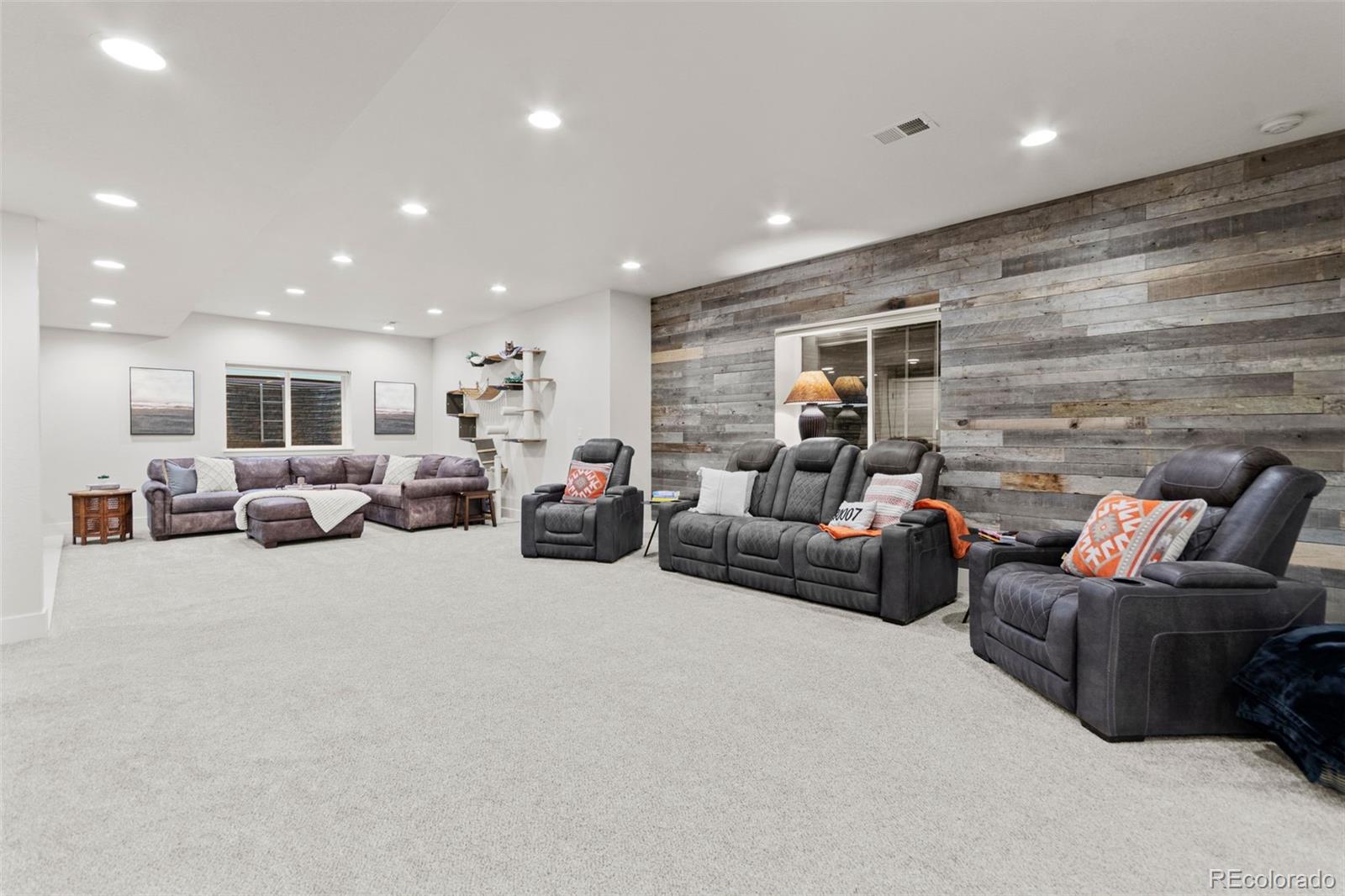 9388 Dunraven Loop Arvada, CO 80007 - Photo 37 of 50 a living room with furniture and a large window