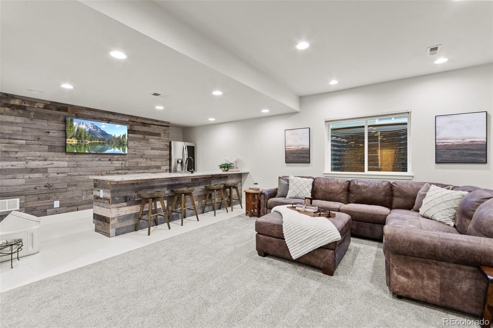 9388 Dunraven Loop Arvada, CO 80007 - Photo 38 of 50 a living room with furniture and a large window