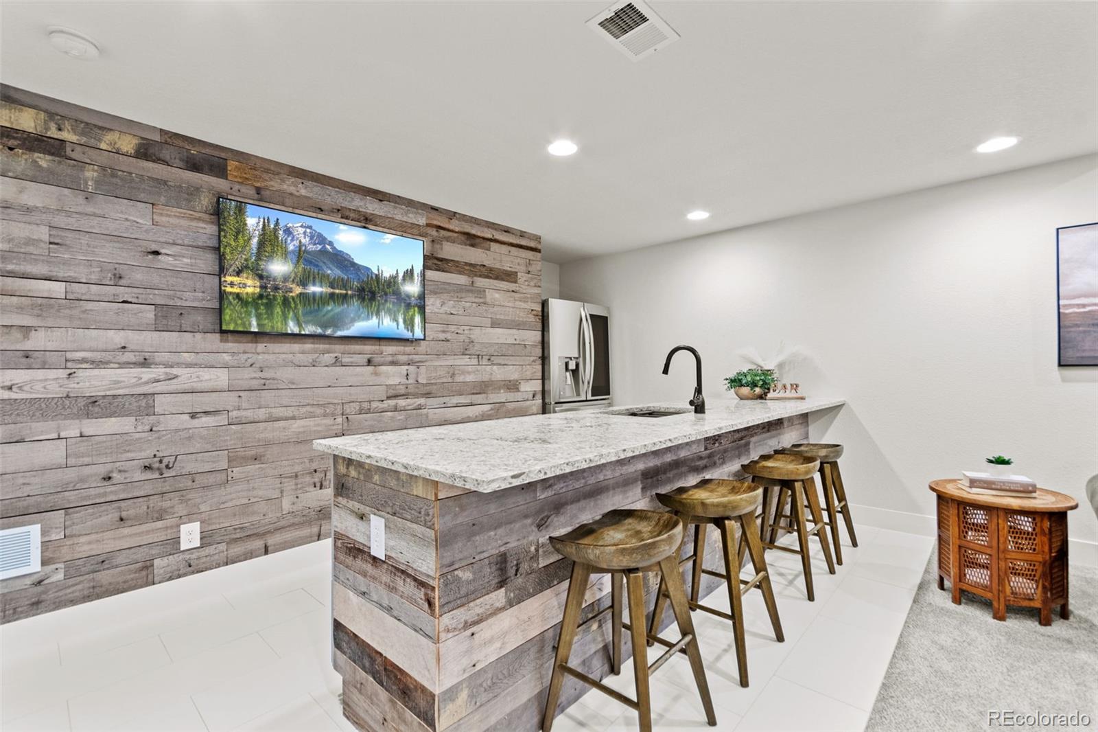 9388 Dunraven Loop Arvada, CO 80007 - Photo 39 of 50 a dining hall with stainless steel appliances granite countertop a stove a sink a refrigerator and a dining table