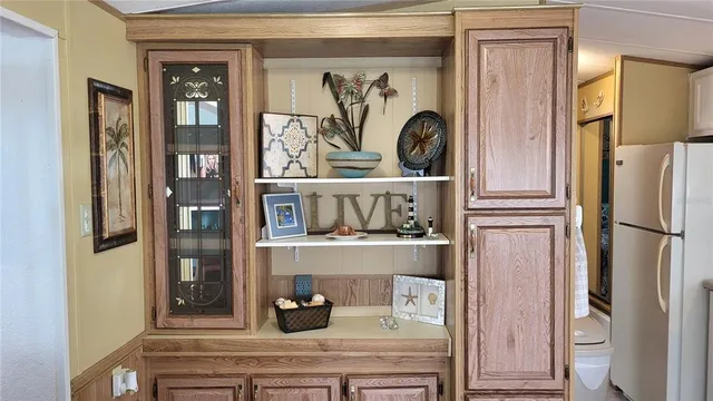 a kitchen with a refrigerator and cabinets