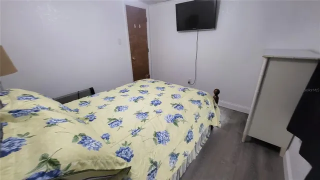 a bedroom with a bed and a dresser