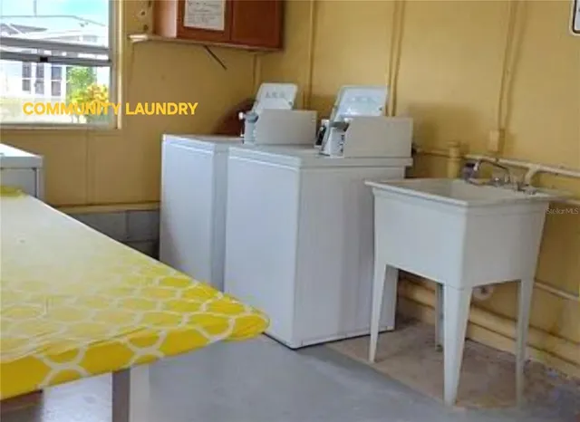 an aerial view of ocean and residential houses with outdoor space