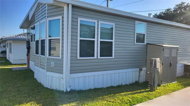 a view of a house with a yard and wooden fence
