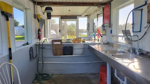 a kitchen with stainless steel appliances a sink a counter top space and a large window