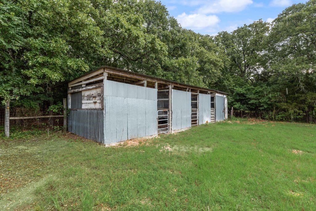 9875 Old Bridge Road Terrell, TX 75160 - Photo 39 of 40 a view of a backyard with barn and large trees