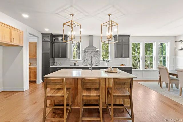 a view of a dining room with furniture a chandelier and wooden floor