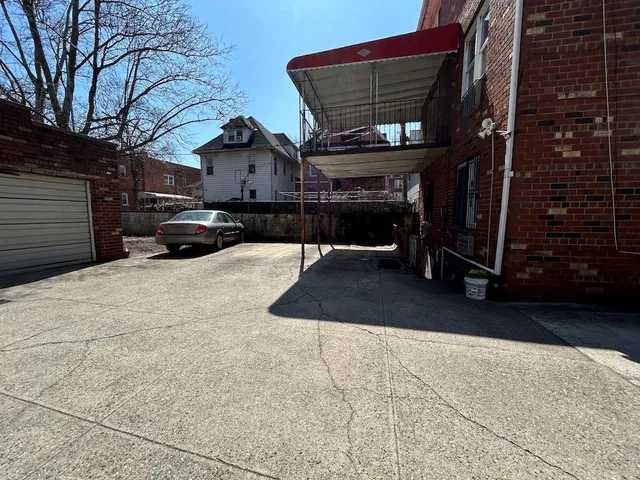 a building with a table and chairs under an umbrella