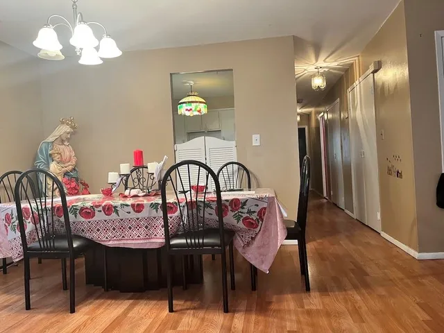 a view of a hallway with wooden floor and entryway