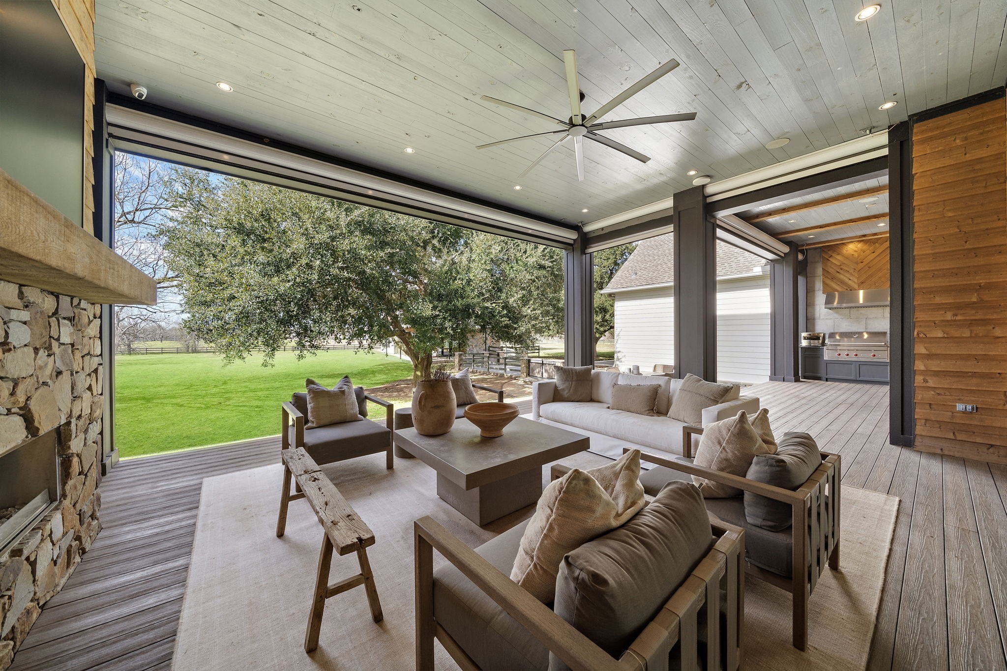 5511 Fulbrook Road Fulshear, TX 77441 - Photo 9 of 50 Incredible covered patio overlooking the backyard and lake. This space along with the summer kitchen can be completely enclosed with automatic roller shades. Summer kitchen includes a 42" Wolf BBQ Grill.