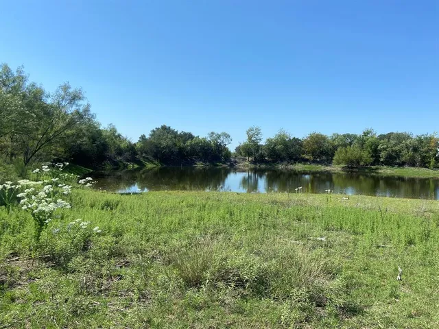 a view of a lake with green space
