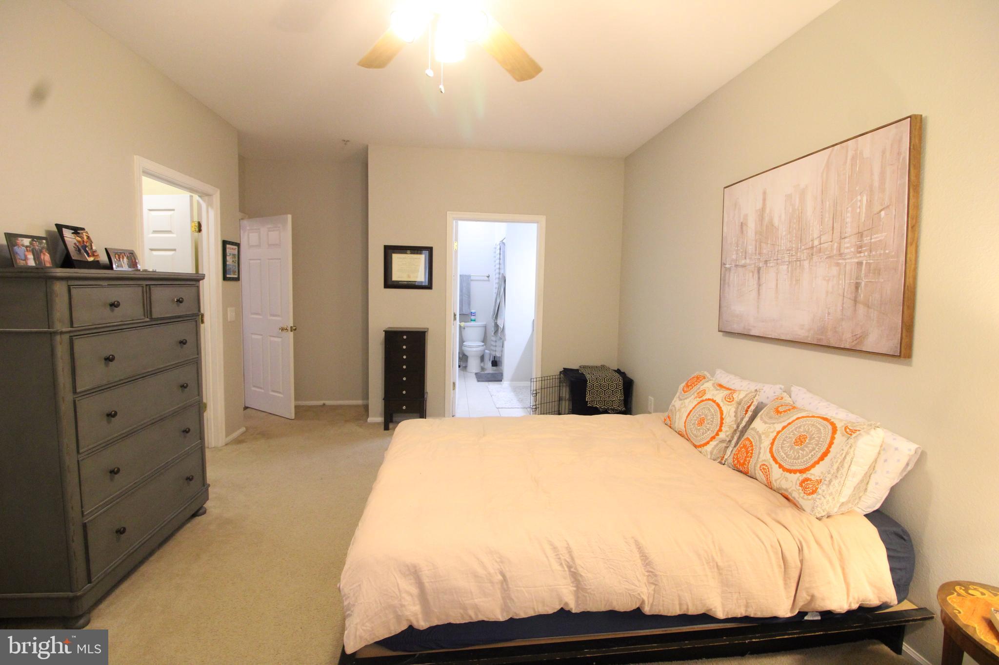 1570 Spring Gate Dr., Unit 7108 McLean, VA 22102 - Photo 12 of 21 a bedroom with a bed and wooden floor