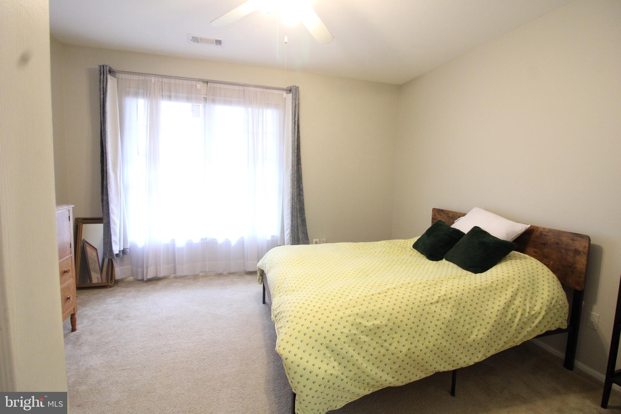 1570 Spring Gate Dr., Unit 7108 McLean, VA 22102 - Photo 15 of 21 a bedroom with a bed and window