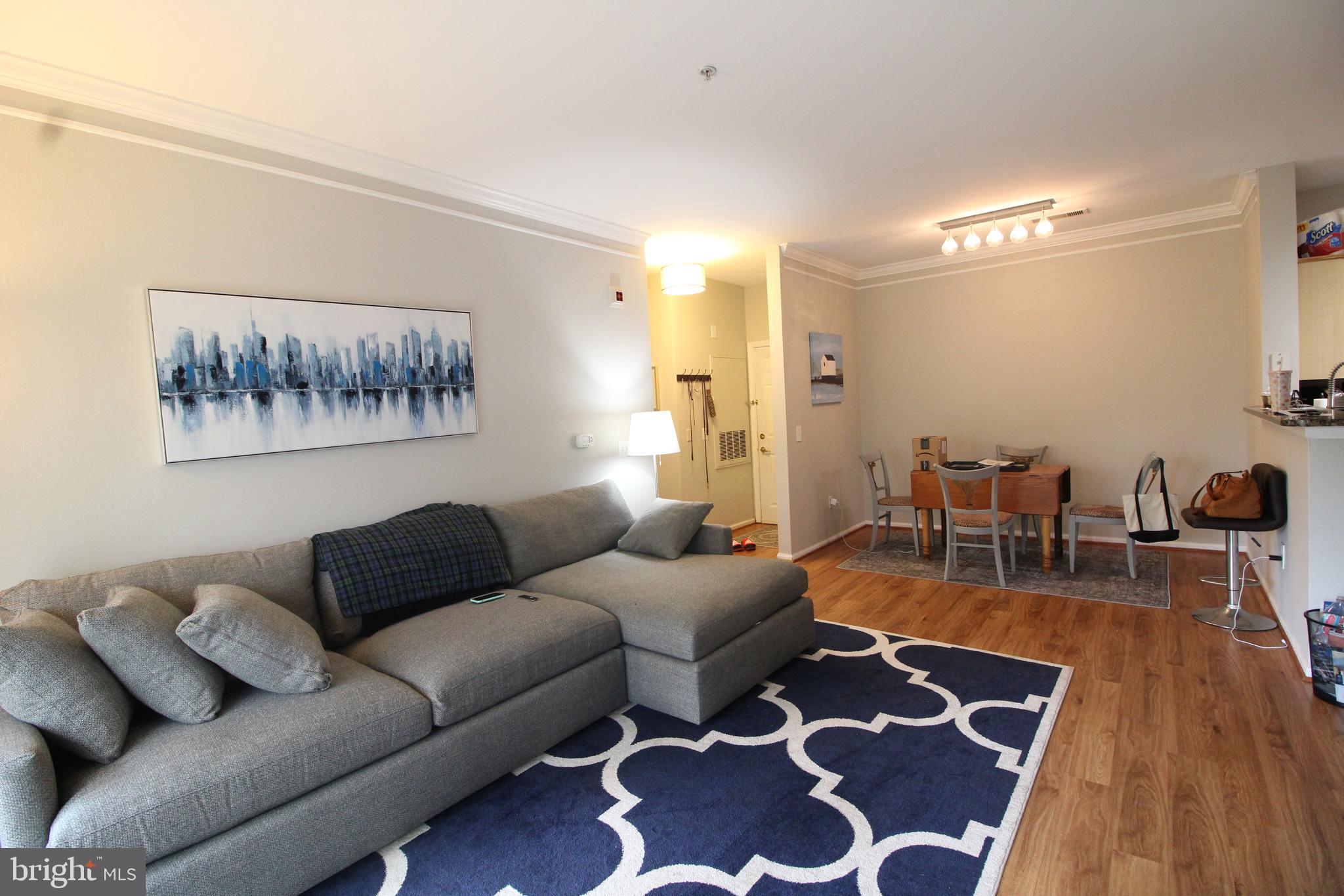 1570 Spring Gate Dr., Unit 7108 McLean, VA 22102 - Photo 2 of 21 a living room with furniture and wooden floor