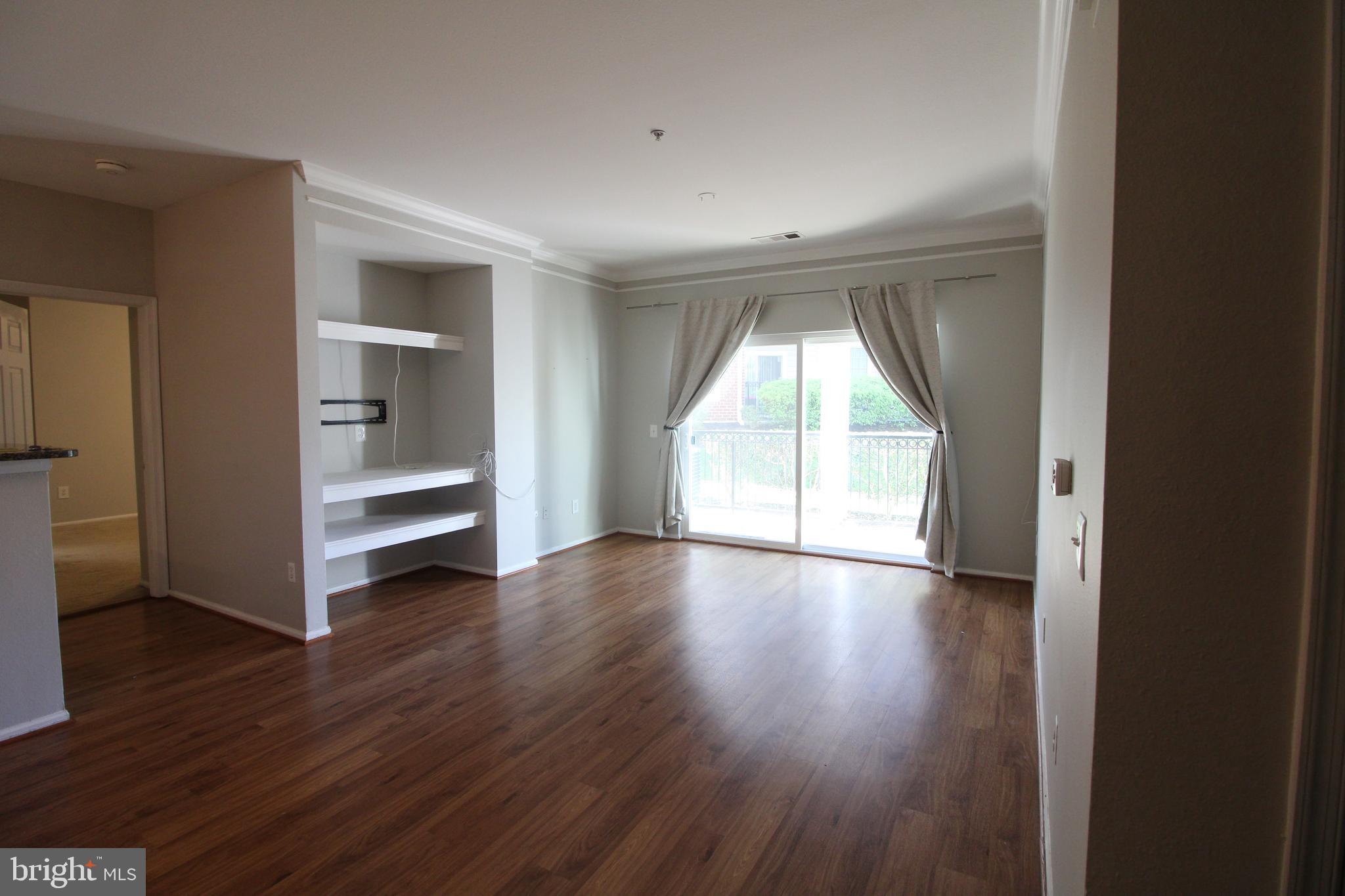 1570 Spring Gate Dr., Unit 7108 McLean, VA 22102 - Photo 3 of 21 a view of empty room with wooden floor and fan