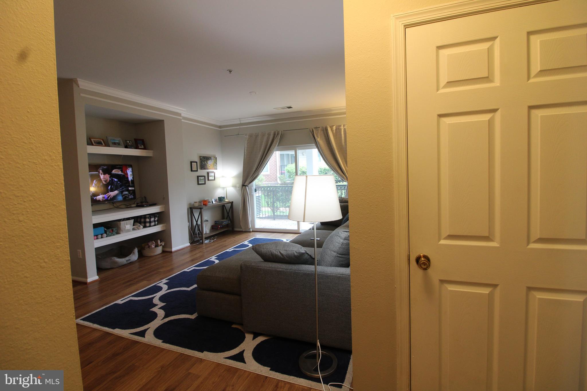 1570 Spring Gate Dr., Unit 7108 McLean, VA 22102 - Photo 4 of 21 a living room with furniture and a window