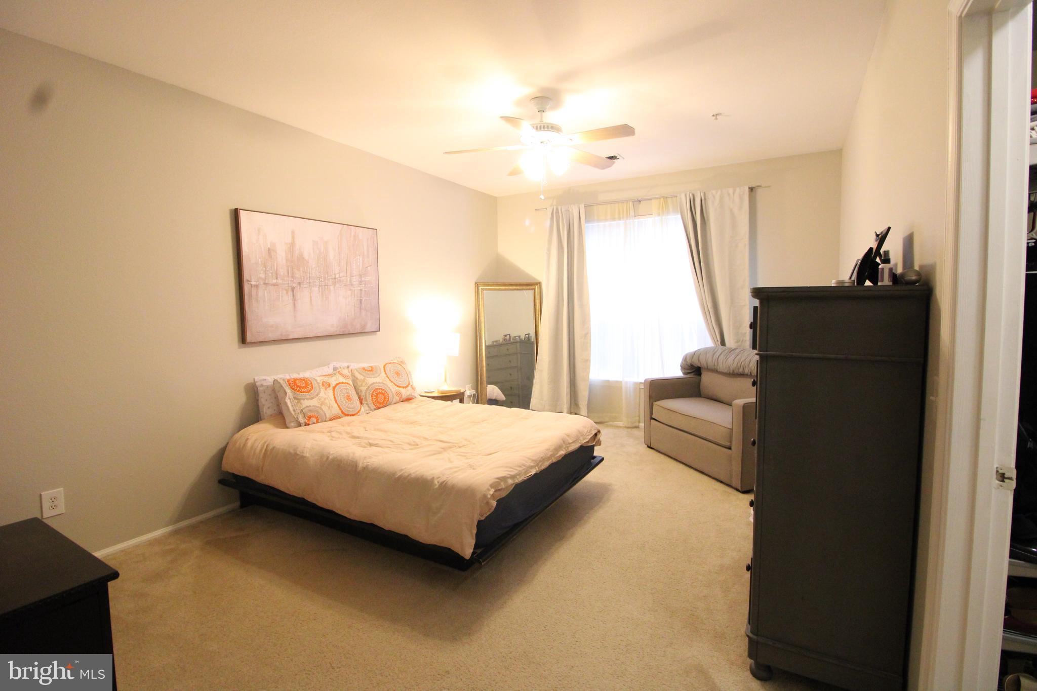 1570 Spring Gate Dr., Unit 7108 McLean, VA 22102 - Photo 8 of 21 a bedroom with a bed and wooden floor