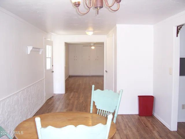 a view of a dining room with furniture wooden floor and front door