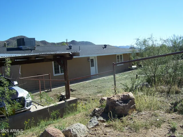 a view of a house with a backyard and a grill