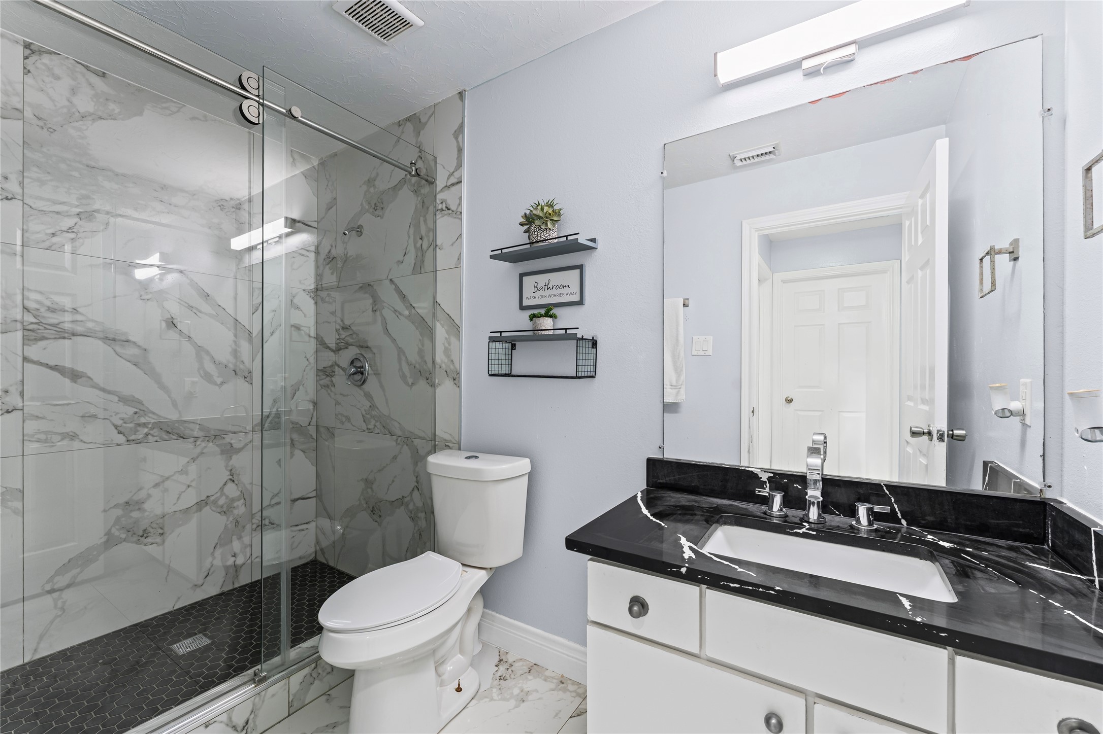 822 Green Pines Forest Houston, TX 77067 - Photo 11 of 18 a bathroom with a granite countertop toilet sink and a shower